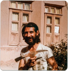 Daei Nooraldin holding a pick axe in front of my mother's family home in Taft, Yazd (Iran.)